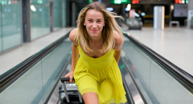Studentessa con valigia in viaggio verso un soggiorno linguistico LISA! in aeroporto