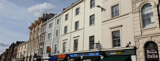 Sprachschule in Exeter von außen mit anderen Nachbargebäuden, Cafes und Restaurants