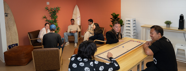 Erwachsene sitzen in der Lounge der LISA! Sprachschule in San Diego und unterhalten sich oder spielen